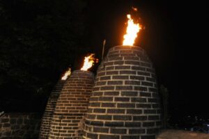 Image of small burning signal towers.